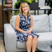 Photo of Angela Higham sitting on a sofa